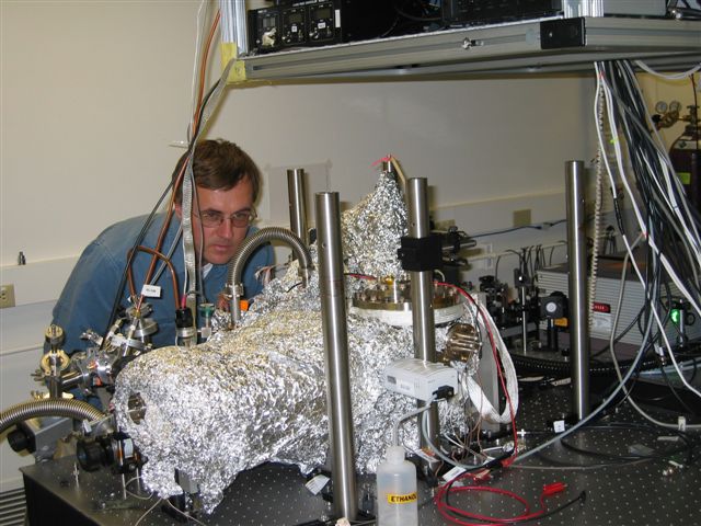 Sergey Egorov, President and CEO of Del Mar Photonics, checks field emission part in Peter Hommelhoff experimental setup